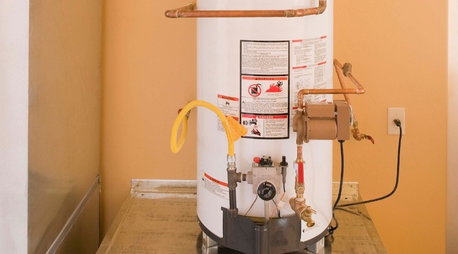 Water heater with visible pipes and valves, showcasing important features for inspection and maintenance, relevant to plumbing services and water heater repair guidance.