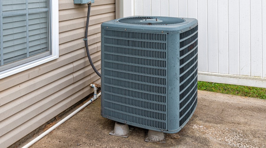 Air conditioning unit outside a home, emphasizing the importance of HVAC maintenance for optimal performance in West Palm Beach's summer heat.