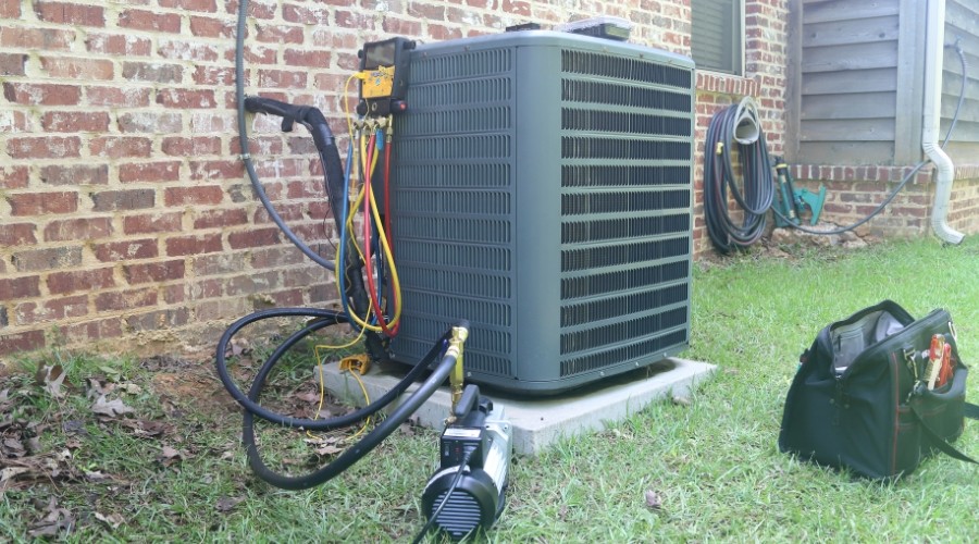 Exterior air conditioning unit and repair tools indicating AC repair needed.